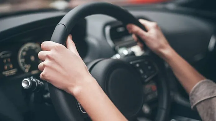 foto mostra motorista com a mão no volante; Saiba se é verdade se precisarão pagar multas para quem ter carro automático