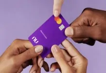 foto mostra pessoas segurando cartão de crédito do nubank